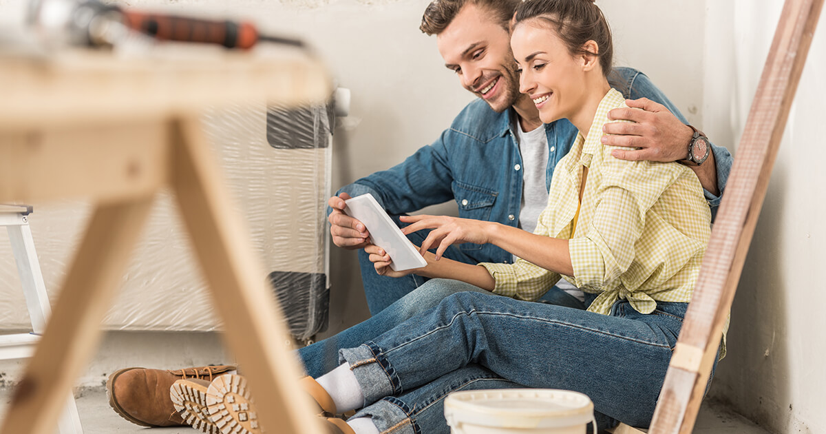 best-time-renovate Couple sitting on the floor in a new home