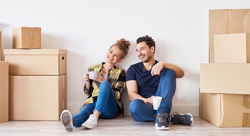 down-payment-needed-to-purchase-home Couple enjoying coffee in new home