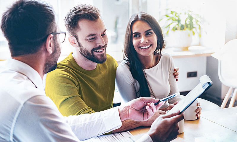 how-do-taxes Couple receiving advice on loan process from professional