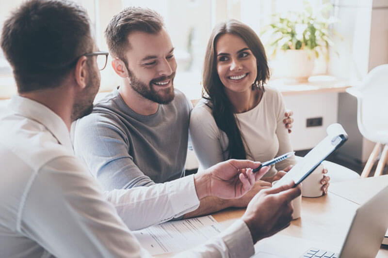 Couple talking with mortgage broker