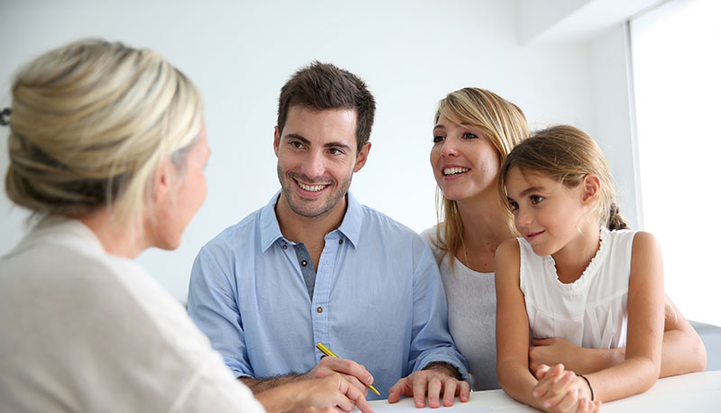 Family going over loan terms with loan officer
