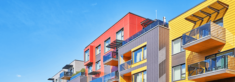 Modern colorful condos against blue sky