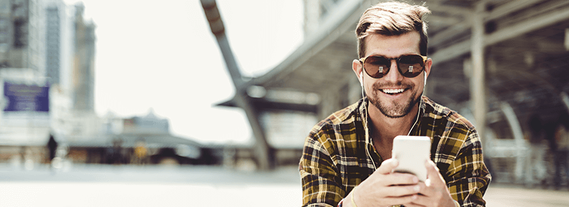 Man in sunglasses looking at smartphone