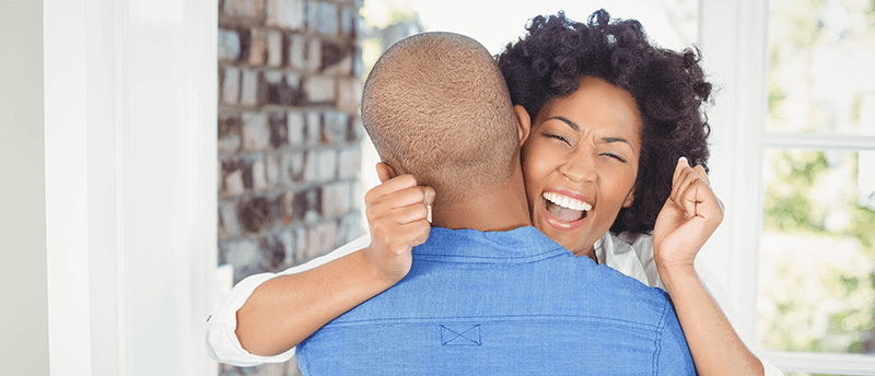 Couple hugging in new home