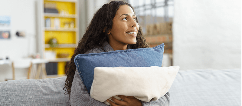 Woman on couch enjoying new home