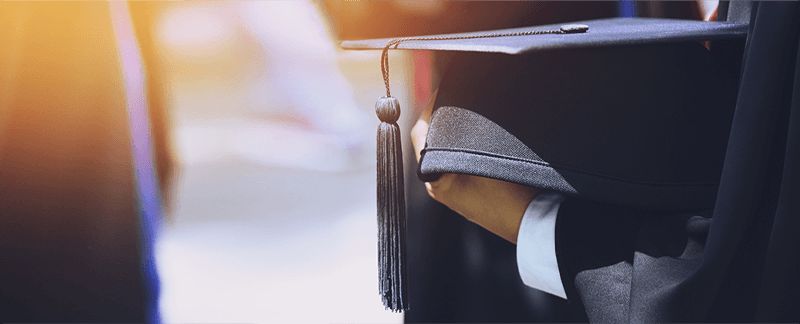 Closeup of student holding graduation cap