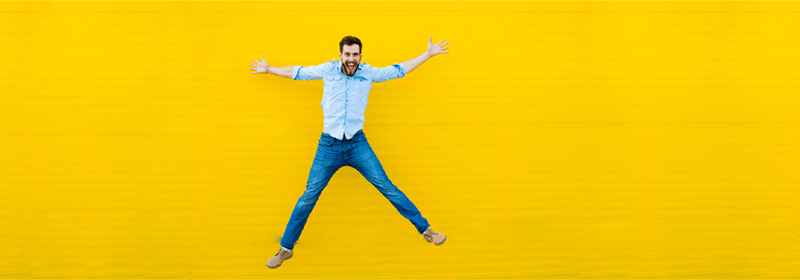 Man celebrating on yellow background