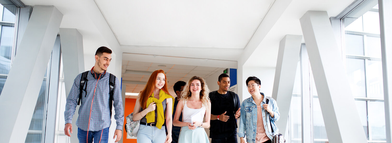 College students walking down school hallway