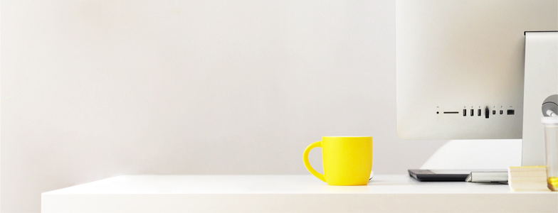 Yellow mug on white table