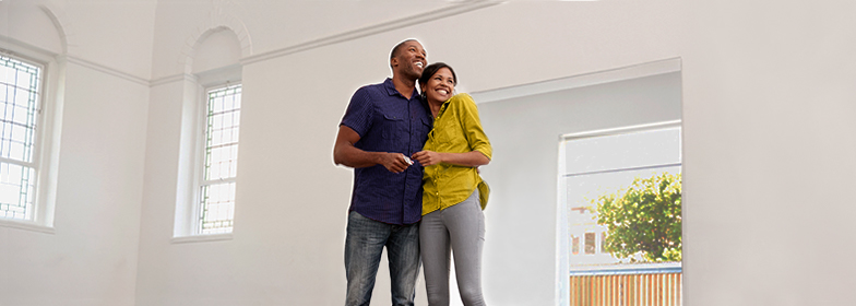 Smiling couple looking at new home