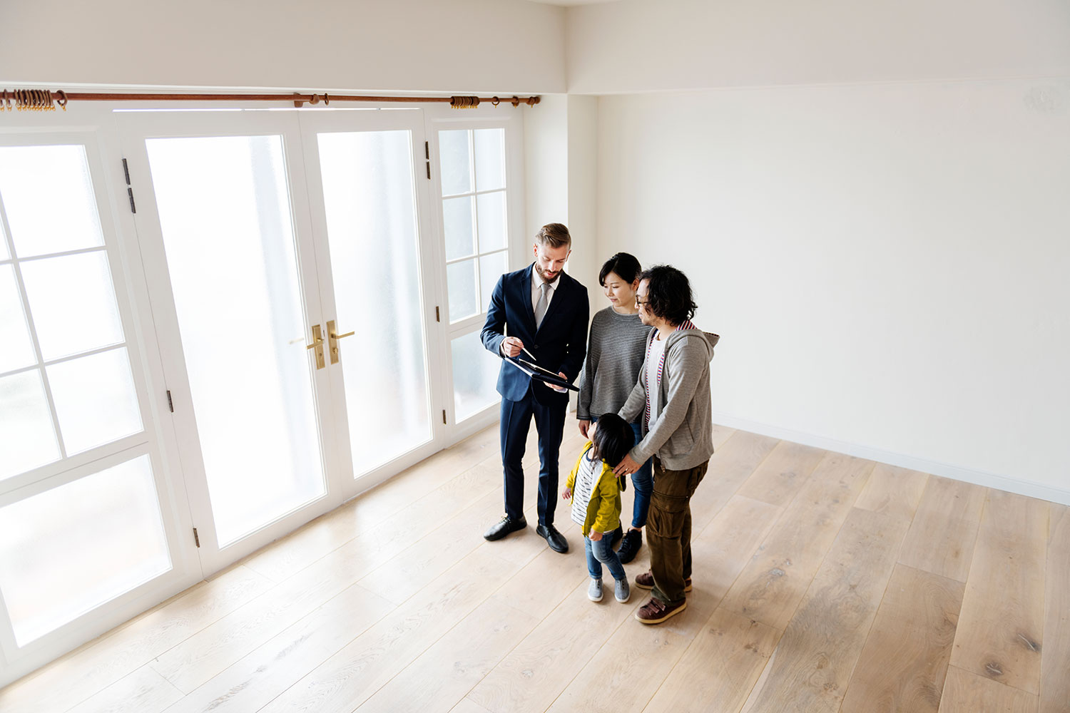 Family with young child viewing home with agent