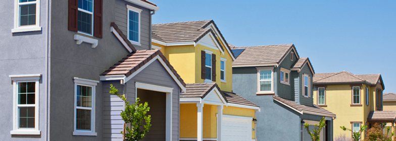 Row of blue and yellow houses on neighborhood street