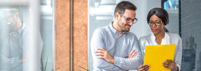 what-does-a-mortgage-closer-do Coworkers reviewing documents in office