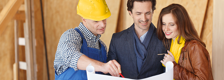 Man and woman talking to a construction worker.