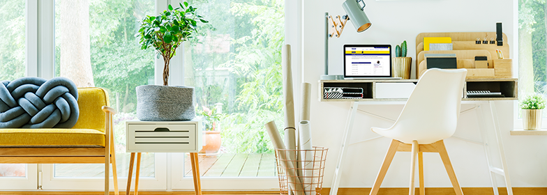 March Blog 3 Someone's office space with their laptop on guildmortgage.com.