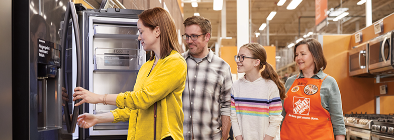 A family looking at appliances in The Home Depot.