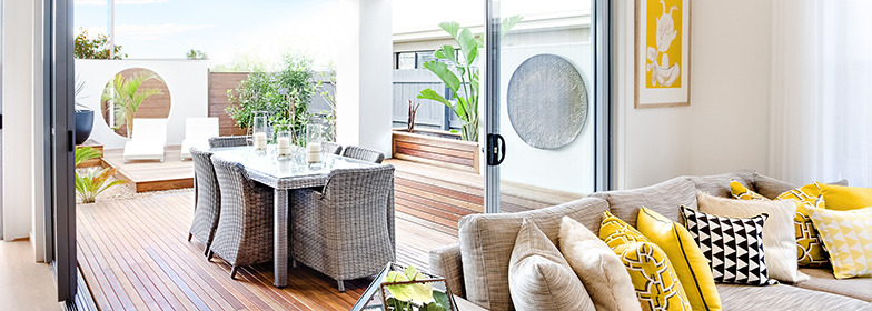 An image of a family room that looks out to the outdoor dining area.