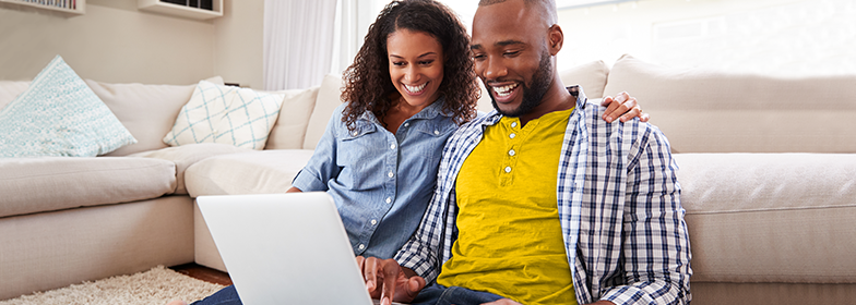 A man and woman looking at a laptop