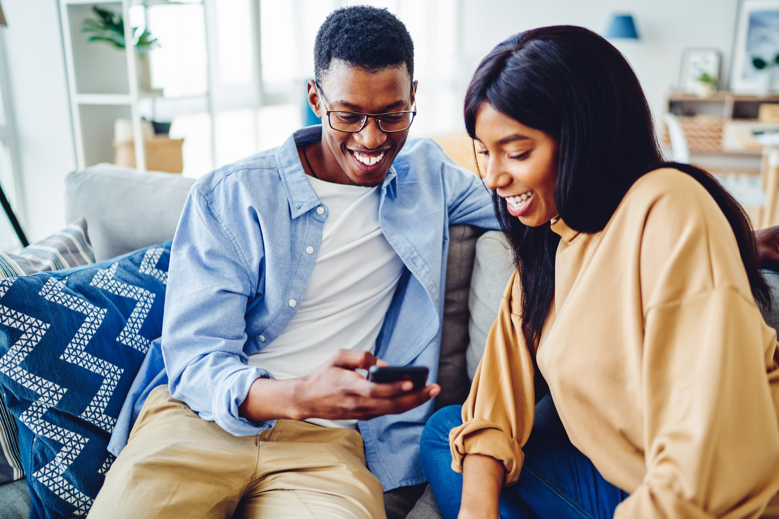 Smiling couple looking at their phone