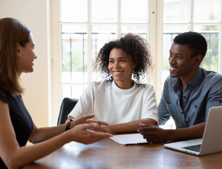 Smiling couple talking to their loan officer