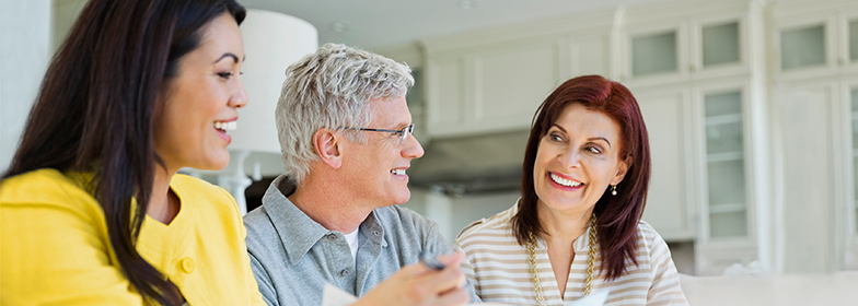 Reverse Mortgage PR An elderly couple talking to their loan officer