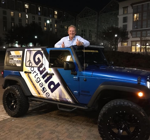 Guild employee in branded jeep