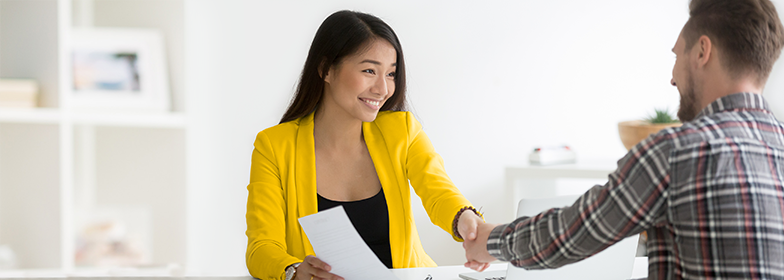 Lowe Group PR A woman shaking hand after signing a deal