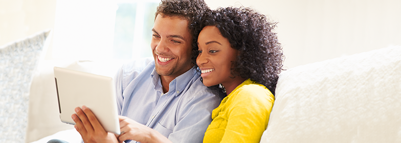 A wife and husband looking at a tablet together