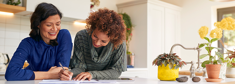 Two women looking at a credit report