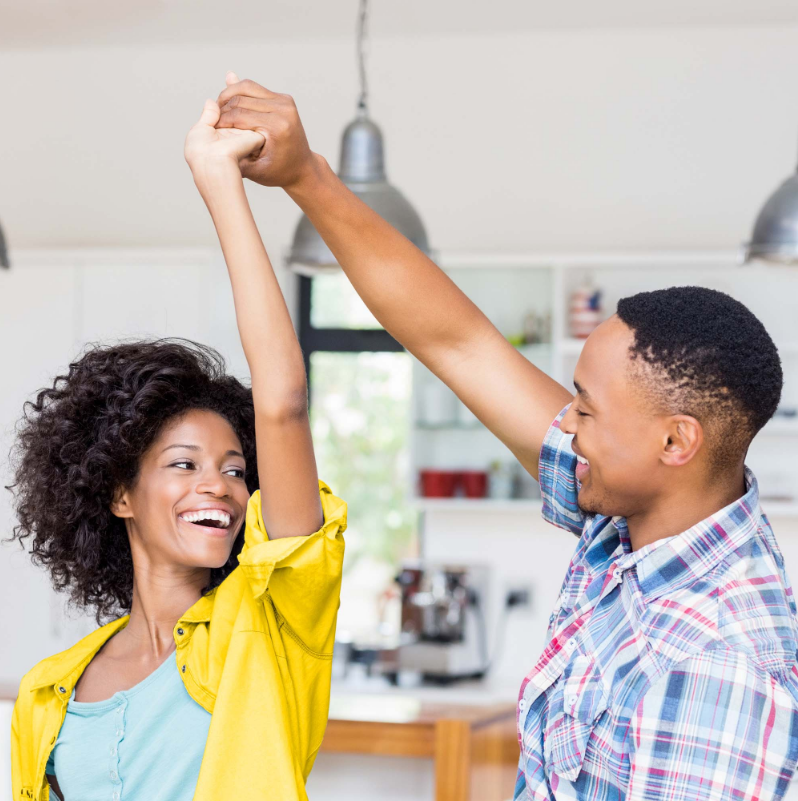 Happy couple dancing in kitchen