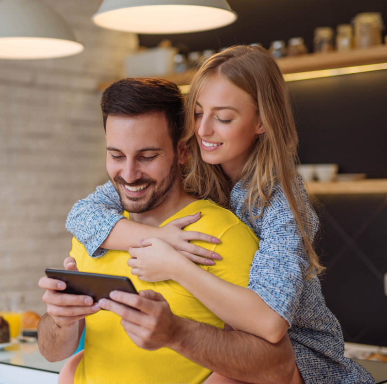 Smiling couple looking at phone