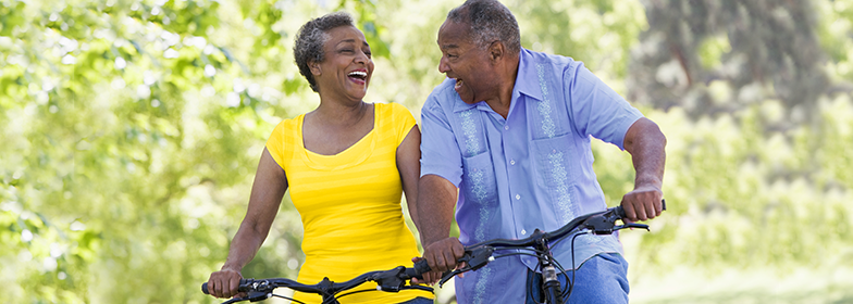 An elderly couple riding their bikes together