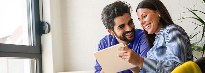 A couple looking at a tablet