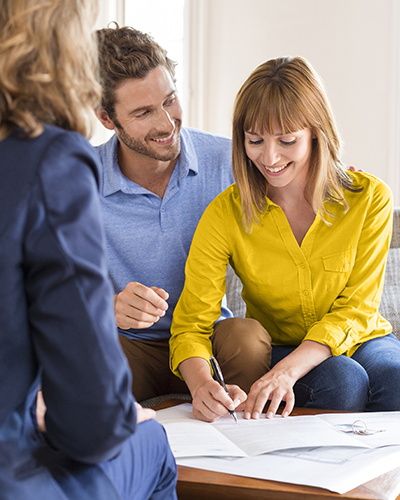 Smiling couple sigining documents