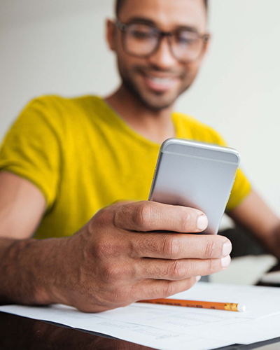 Happy man looking at his phone