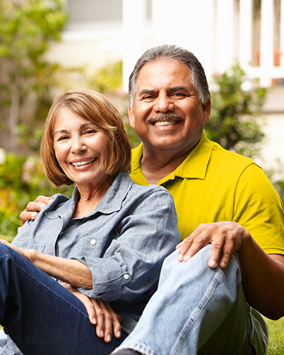 Happy couple sitting on lawn