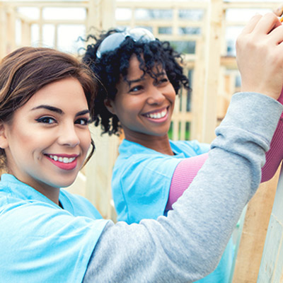 Two women building a house