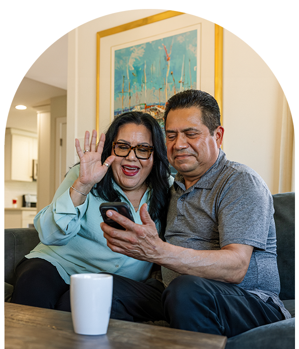 Smiling couple on phone with family