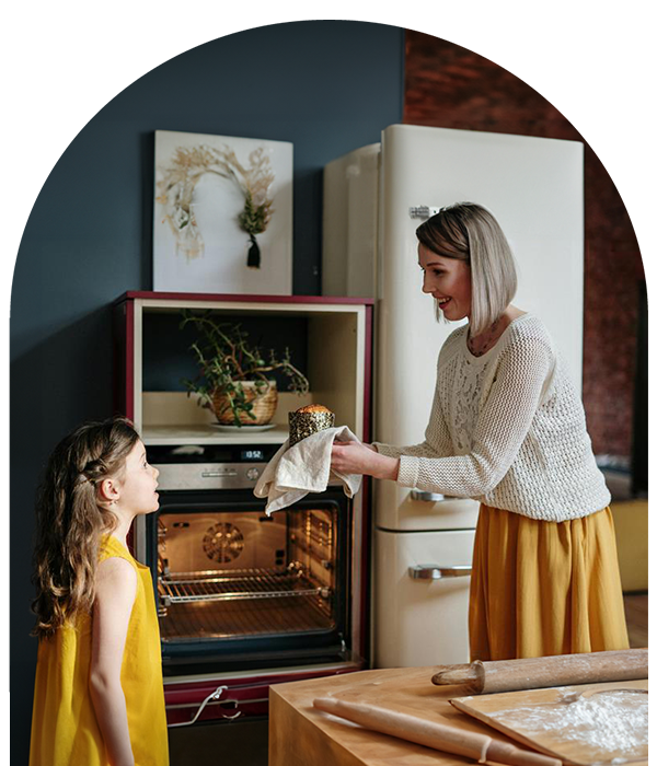 Mother and daughter baking in kitchen