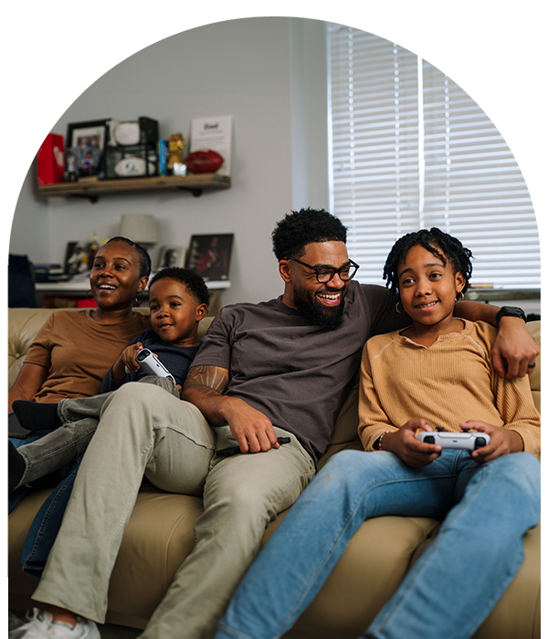 Family playing video games on the couch