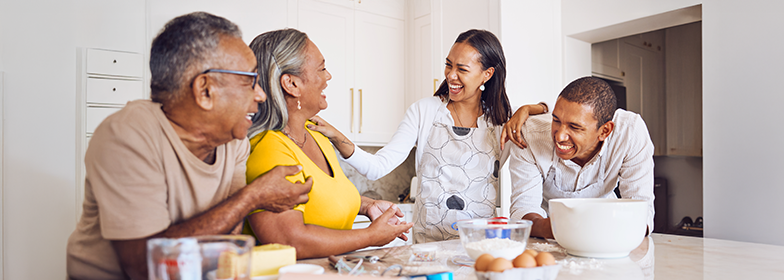 Blog – How to use home equity Family laughing around kitchen counter