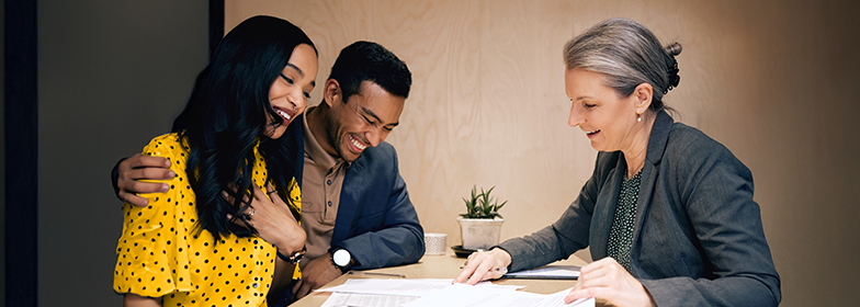 Smiling couple working with Loan Officer