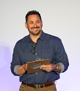 Jayson Stebbins on stage at Elevate event